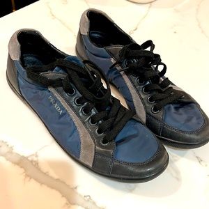 Navy blue Prada tennis shoes.